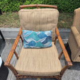Rattan Armchair With Neutral Pillows And Ottoman